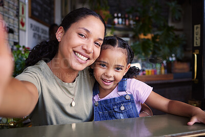 Buy stock photo Cafe, black family and selfie with a mother and daughter enjoying spending time together in a coffee shop. Portrait, kids and smile with a woman and happy female child bonding in a restaurant