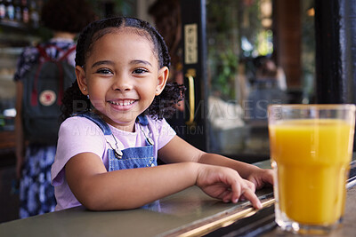 Buy stock photo Happy, smile and portrait of a child at a restaurant for food, breakfast and juice. Playful, happiness and girl sitting in a cafe, coffee shop or store for lunch, dinner or meal with a drink