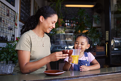 Buy stock photo Coffee shop, black family and toast with a mother and daughter enjoying a beverage in a cafe together. Juice, caffeine and cheers with a woman and happy female child bonding in a restaurant