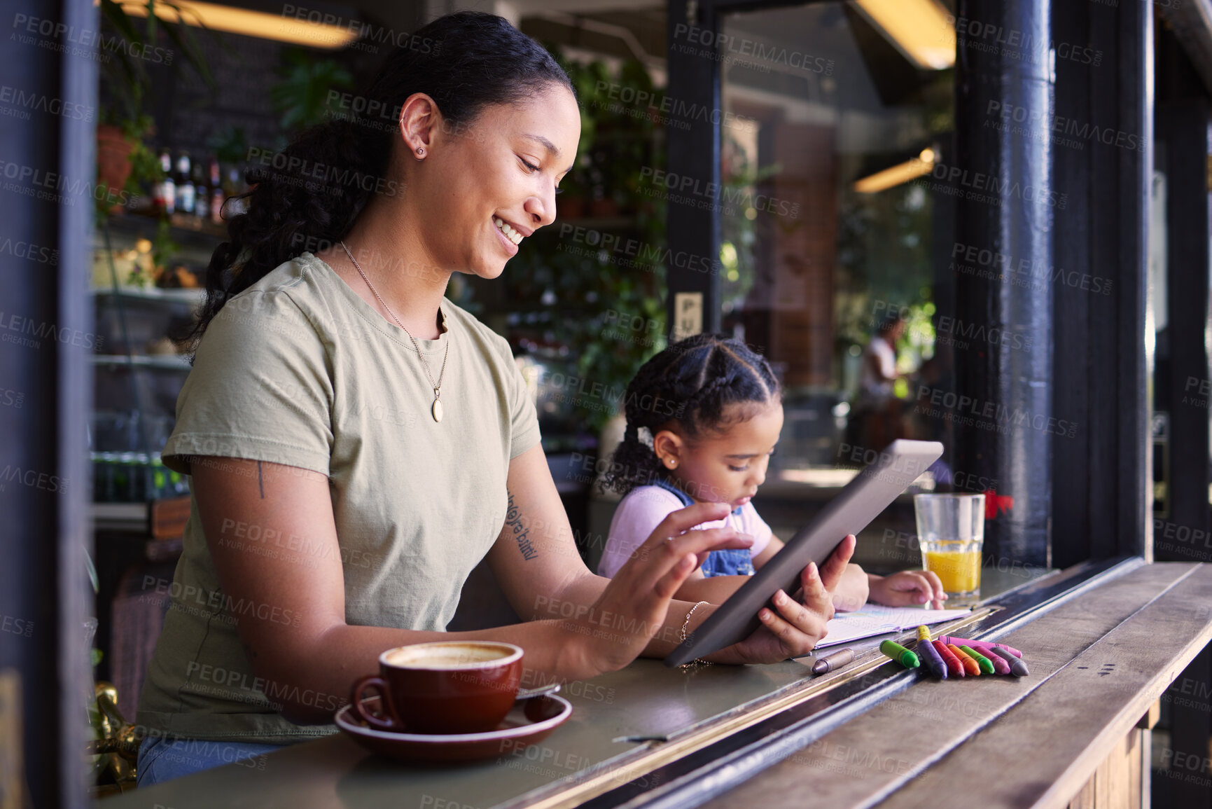 Buy stock photo Black family, children and mother remote working at a cafe together with her daughter coloring in a book. Tablet, internet or coffee shop with a woman freelancer and her female child at a restaurant