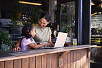 Black family, coffee shop or laptop with a mother and daughter together in the window of a restaurant. Kids, computer or education with a woman and female child sitting or bonding in a internet cafe