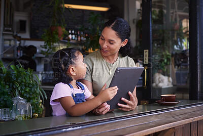 Buy stock photo Streaming, cafe and woman and girl with a tablet talking while on social media, online and app at a coffee shop. Kid, daughter and child with mother on the internet for browsing the web or website