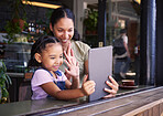 Video call, restaurant and woman and girl with a tablet waving on social media, online and app at a coffee shop. Kid, daughter and child with parent on the internet for communication and talking