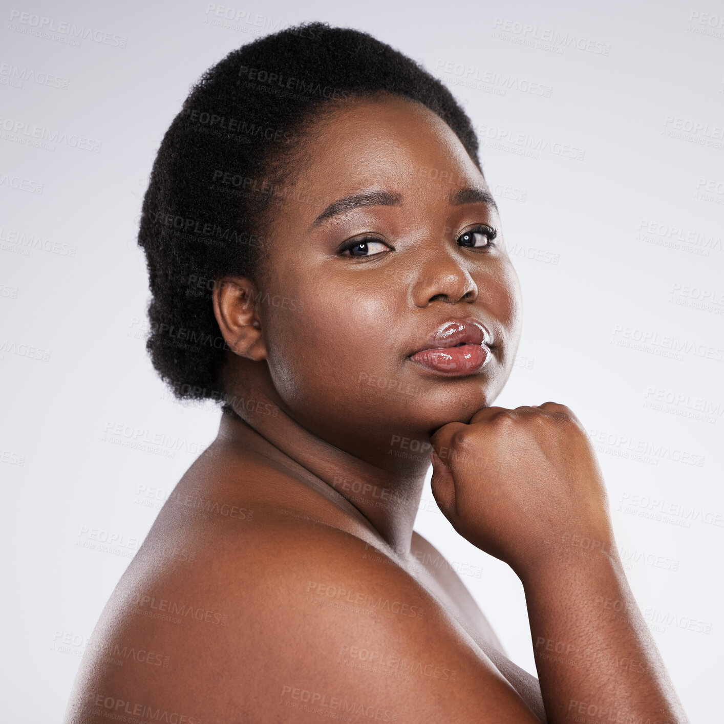 Buy stock photo Confident black woman, hand and chin in skincare beauty, cosmetics or makeup against a gray studio background. Portrait of proud African American female plus size model in self love, care or facial