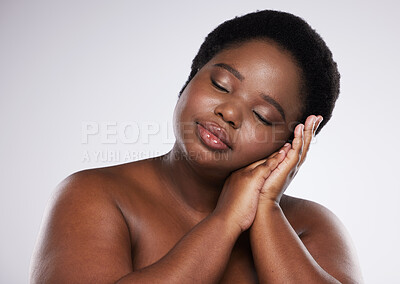 Buy stock photo Relax, skincare beauty or black woman with makeup or cosmetics isolated on a gray studio background. Hands, face or African plus size model resting with spa facial products for self love or care
