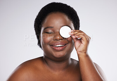 Buy stock photo Beauty, skincare and plus size with a model black woman in studio on a gray background for exfoliation. Face, skin and cotton swab with an attractive young female posing to promote natural health