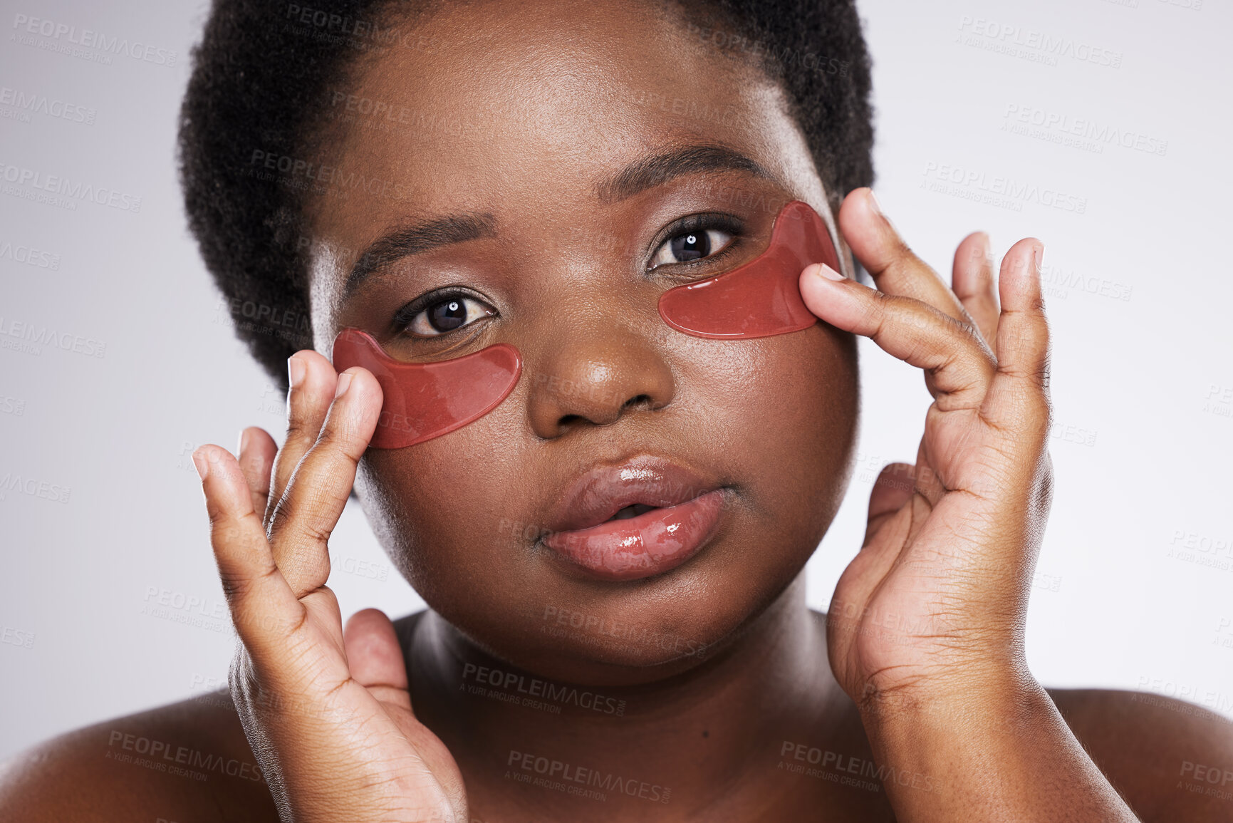 Buy stock photo Black woman, face and portrait with eye patch for skincare, healthy skin and glow isolated on studio background. Hands, shine and natural cosmetics, dermatology and facial mask with beauty care