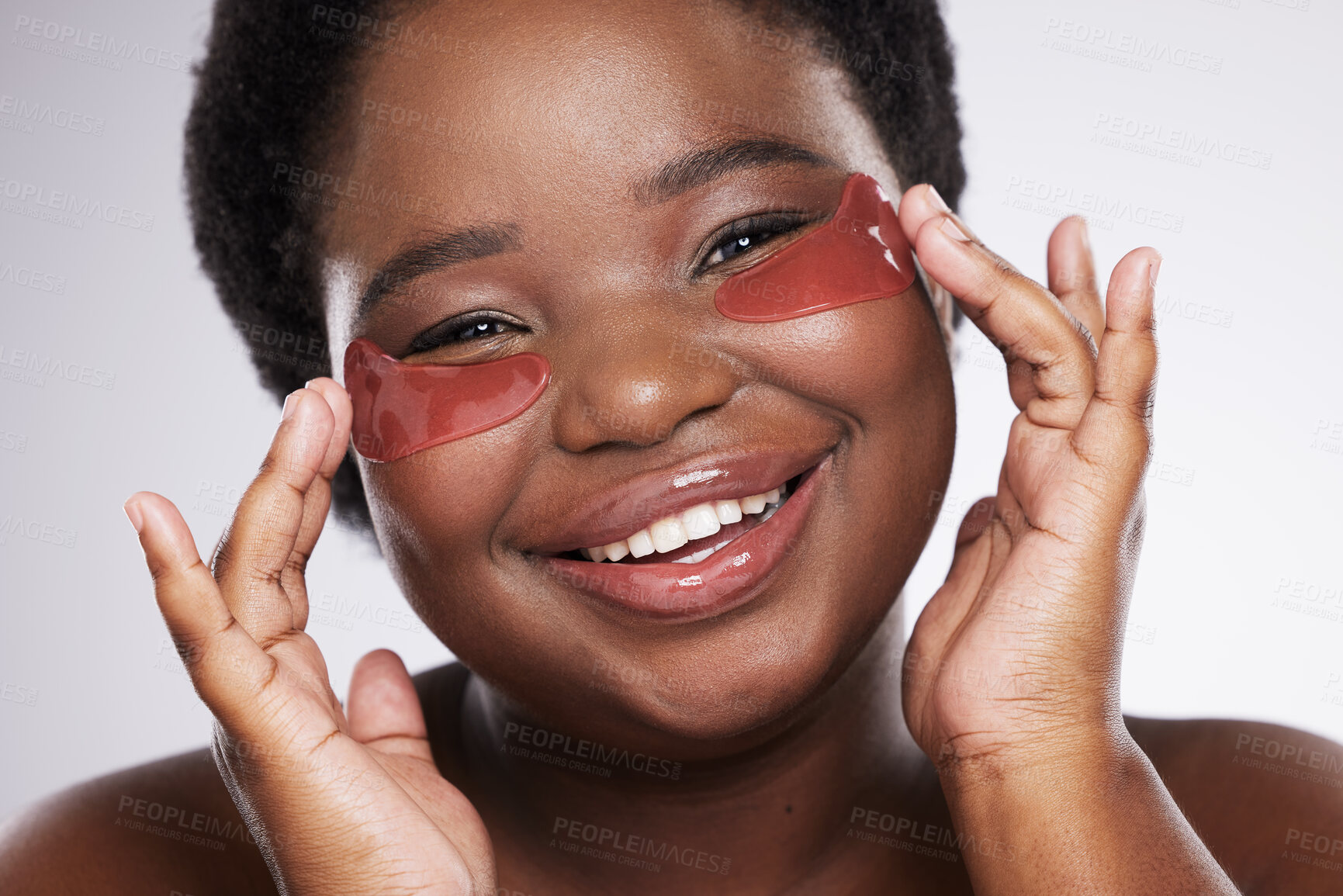 Buy stock photo Black woman, face and happy with eye patch for skincare, healthy skin and portrait isolated on studio background. Hands, shine and natural cosmetics, dermatology and facial care with beauty mask