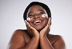 Thinking, skincare and cream with a model black woman in studio on a gray background for plus size beauty. Idea, skin and lotion with an attractive young female touching her face after treatment