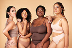 Body positive, diversity and portrait of women group together for inclusion, beauty and power. Underwear model people or friends on beige background for skincare, pride and motivation for self love