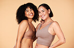 Diversity, friends and beauty of women in underwear in studio isolated on a brown background. Portrait, lingerie and body positive happy girls with makeup, cosmetics and healthy skincare for wellness