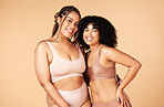 Skincare, beauty and black women friends in underwear in studio isolated on a brown background. Empowerment portrait, lingerie and body positive happy girls with makeup, cosmetics and healthy skin.