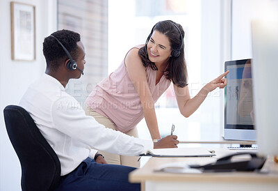 Buy stock photo Woman, consulting and pointing at computer in call center for help, coaching or advice for diversity, Crm teamwork, desktop pc or helping hand in tech support, customer service training or internship