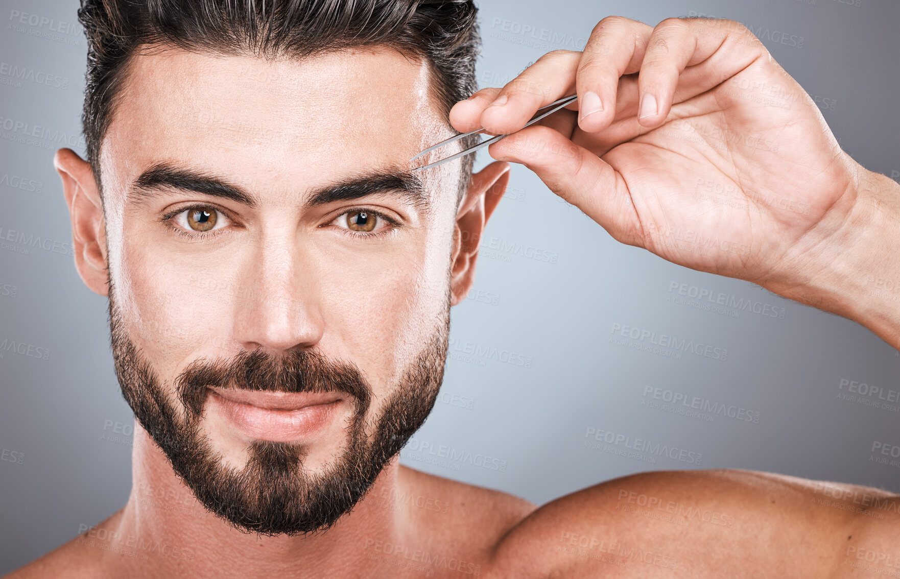 Buy stock photo Face portrait, eyebrow and man with tweezers in studio isolated on a gray background for wellness. Health, hair removal and male model with facial product to pluck eyebrows for grooming and beauty.