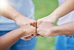 People, hands and fist bump in collaboration for community, partnership or trust together in the outdoors. Hand of team bumping fists in unity for agreement, coordination or support in solidarity