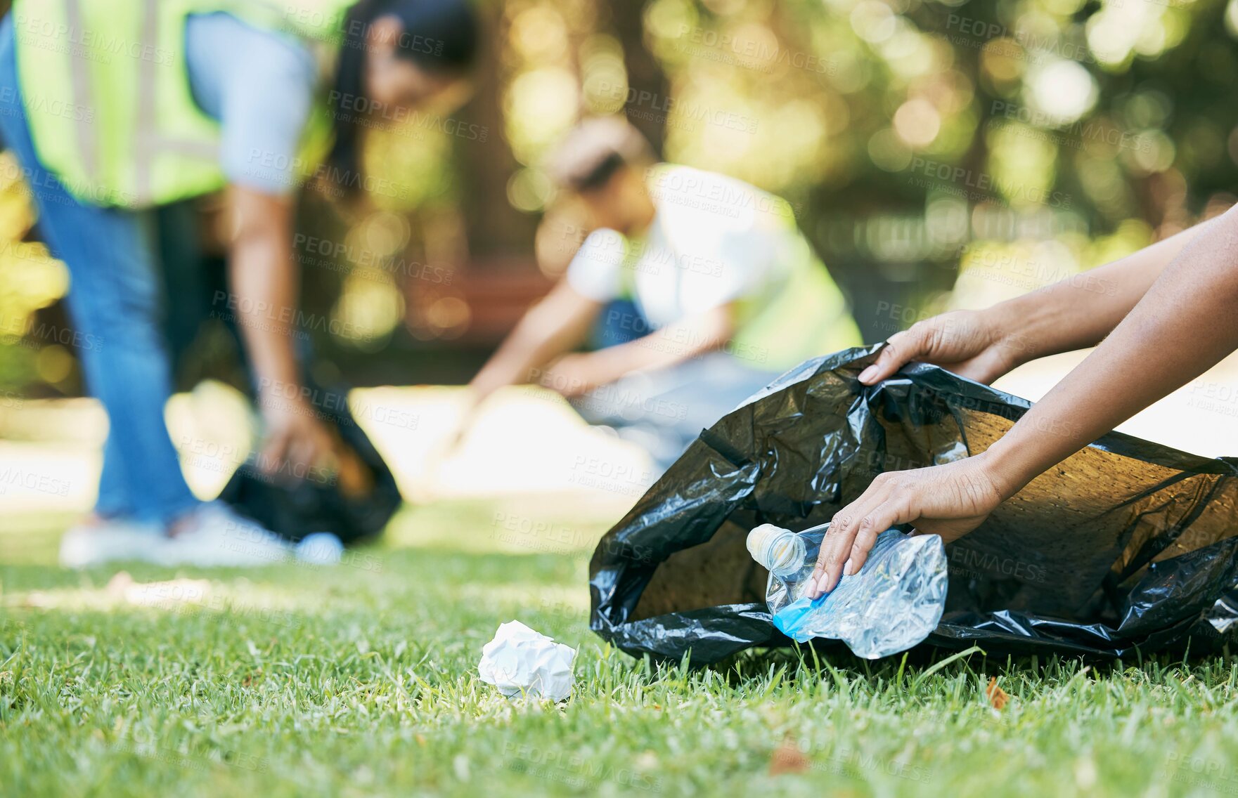 Buy stock photo Volunteer hands, cleaning up and trash bag for pollution,  carbon footprint and eco friendly in park. Closeup, zoom and plastic collection outdoor, sustainability and charity service for environment