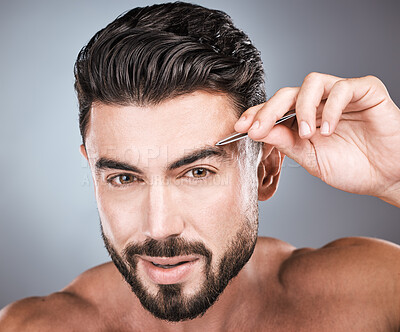 Buy stock photo Face, portrait and man with tweezers in studio isolated on a gray background for wellness. Health, hair removal and male model with facial product to pluck eyebrows for grooming, hygiene and beauty.