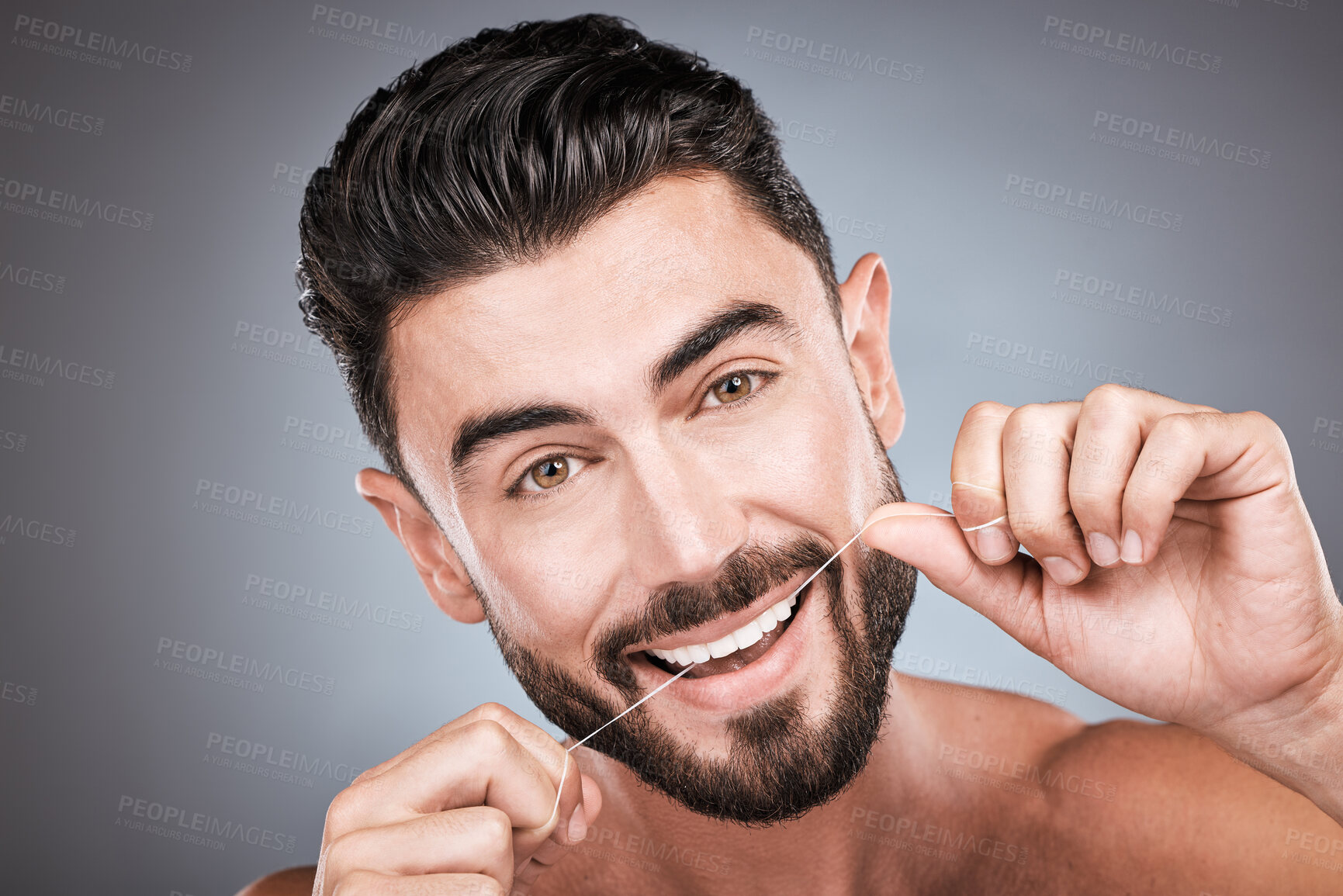 Buy stock photo Dental floss, teeth and portrait of man in studio for beauty, healthy body and hygiene on background. Male model, tooth flossing and cleaning mouth for facial smile, fresh breath and happy cosmetics