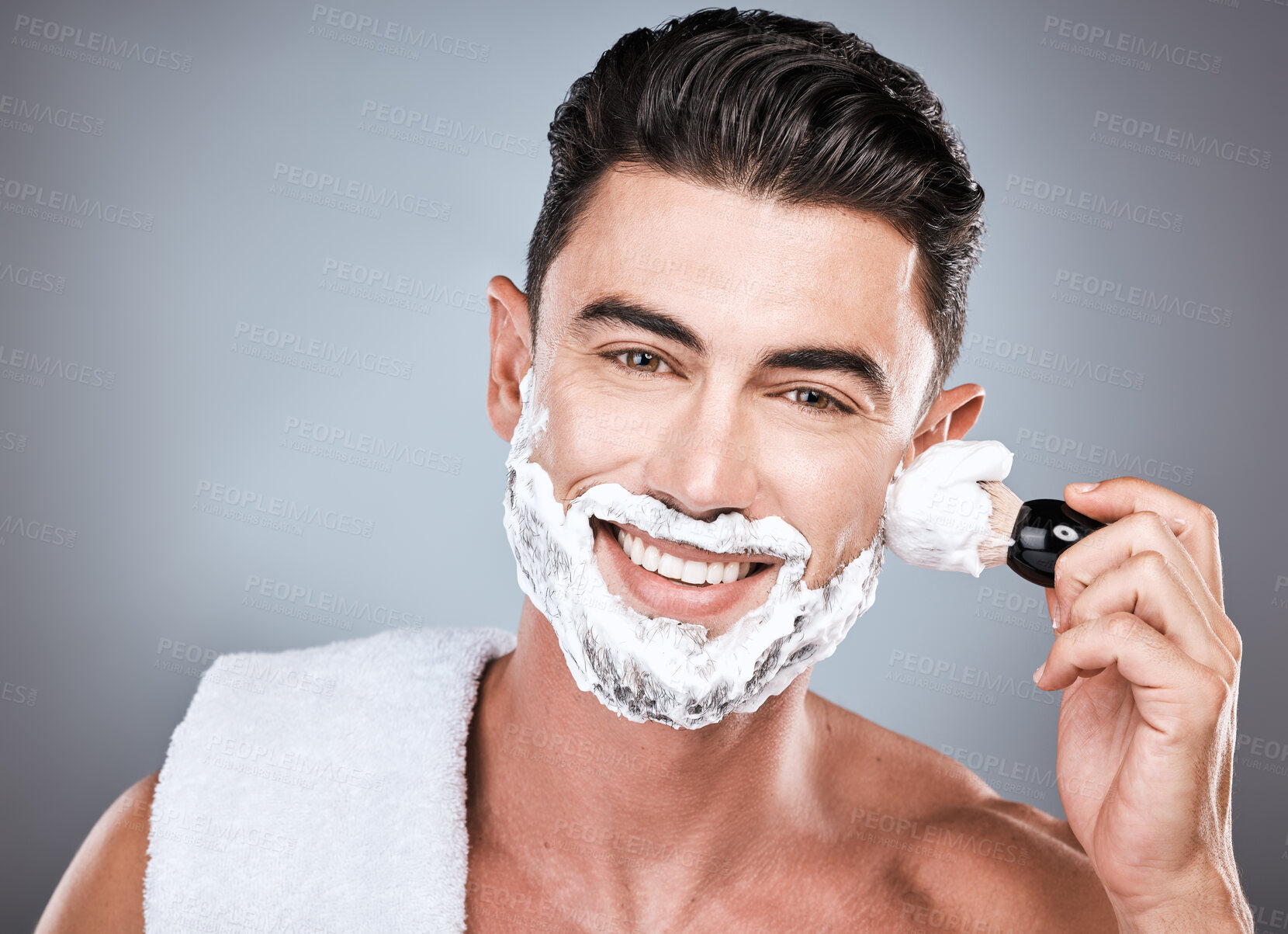 Buy stock photo Face, shaving cream and man with brush in studio isolated on gray background for hair removal. Haircare portrait, epilation and happy male model with facial product, foam or gel to shave for wellness