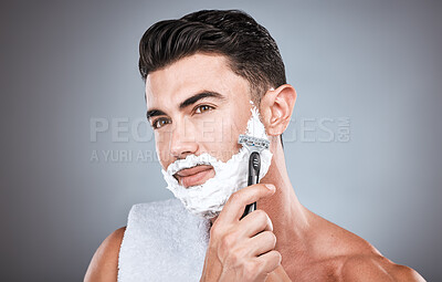 Buy stock photo Face, shaving cream and man with razor in studio isolated on a gray background. Skincare, cleaning and thinking male model with facial product, foam or gel to shave for wellness, health and hygiene.