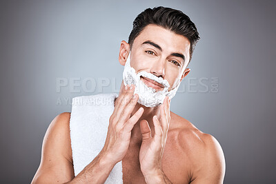 Buy stock photo Portrait, shave cream and grooming with a man model in studio on a gray background for hair removal. Face, hand and skincare with a handsome young male in the bathroom for shaving in the morning