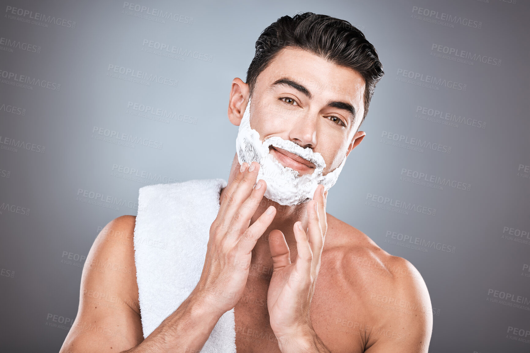 Buy stock photo Portrait, shave cream and grooming with a man model in studio on a gray background for hair removal. Face, hand and skincare with a handsome young male in the bathroom for shaving in the morning