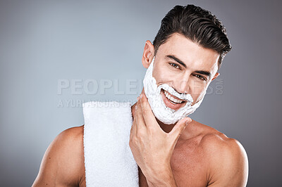 Buy stock photo Portrait, shaving cream and grooming with a man model in studio on a gray background for hair removal. Face, hand and skincare with a handsome young male in the bathroom for a shave in the morning