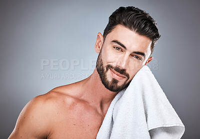 Buy stock photo Skincare, health and portrait of a man in a studio with a cosmetic, natural and face routine. Wellness, healthy and handsome male model with a facial towel for treatment isolated by a gray background