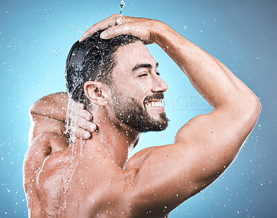 Buy stock photo Back skincare, water splash and man in shower in studio isolated on a blue background. Wellness, dermatology and face of happy male model cleaning, washing and bathing for healthy skin and hygiene.