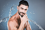 Water splash, beauty and shower with man in portrait for hygiene and skincare isolated on studio background. Hand, face and cleaning body with muscle, sustainable dermatology with natural cosmetics