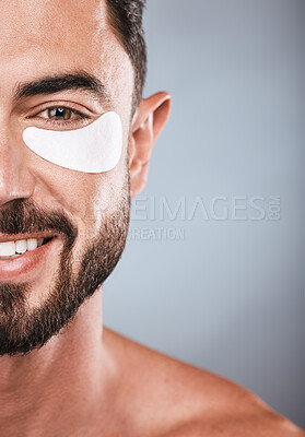 Buy stock photo Half, face and man with eye patch in studio isolated on a gray background for wellness. Portrait, skincare or male model with cosmetics, facial treatment or product for eyes, wellness or healthy skin