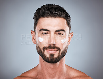 Buy stock photo Skincare, cream and face portrait of man in studio isolated on a gray background for wellness. Cosmetics, dermatology and young male model with lotion, creme or moisturizer product for facial health.