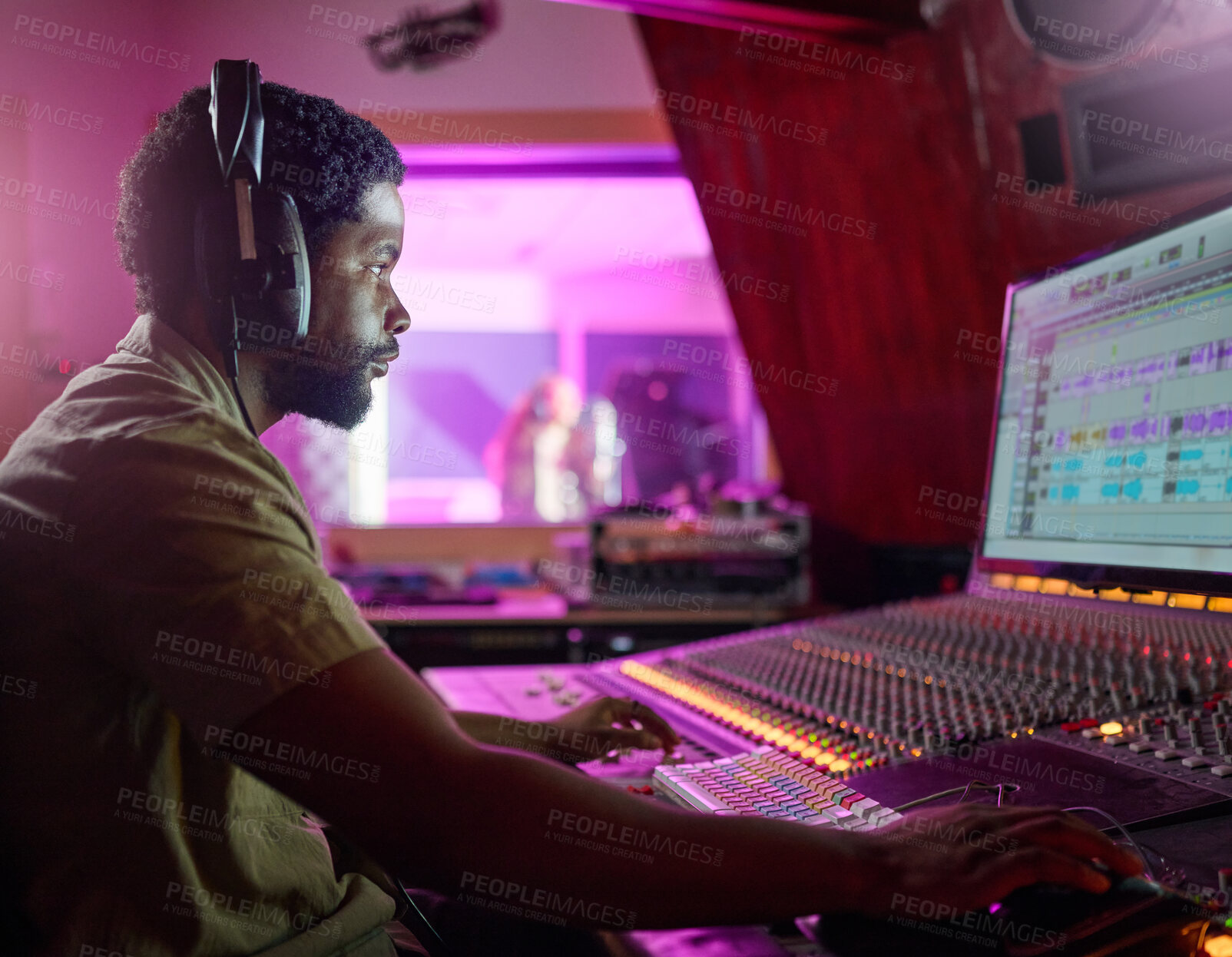 Buy stock photo Black man, studio recording and music job in night with headphones, computer or focus by mixing console. Sound engineer, producer or audio technology for professional production of hit song for radio