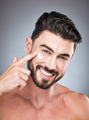 Buy stock photo Skincare, clean and portrait of a man with face cream isolated on a grey studio background. Beauty, grooming and model applying facial sunscreen for body dermatology, hygiene and sun protection