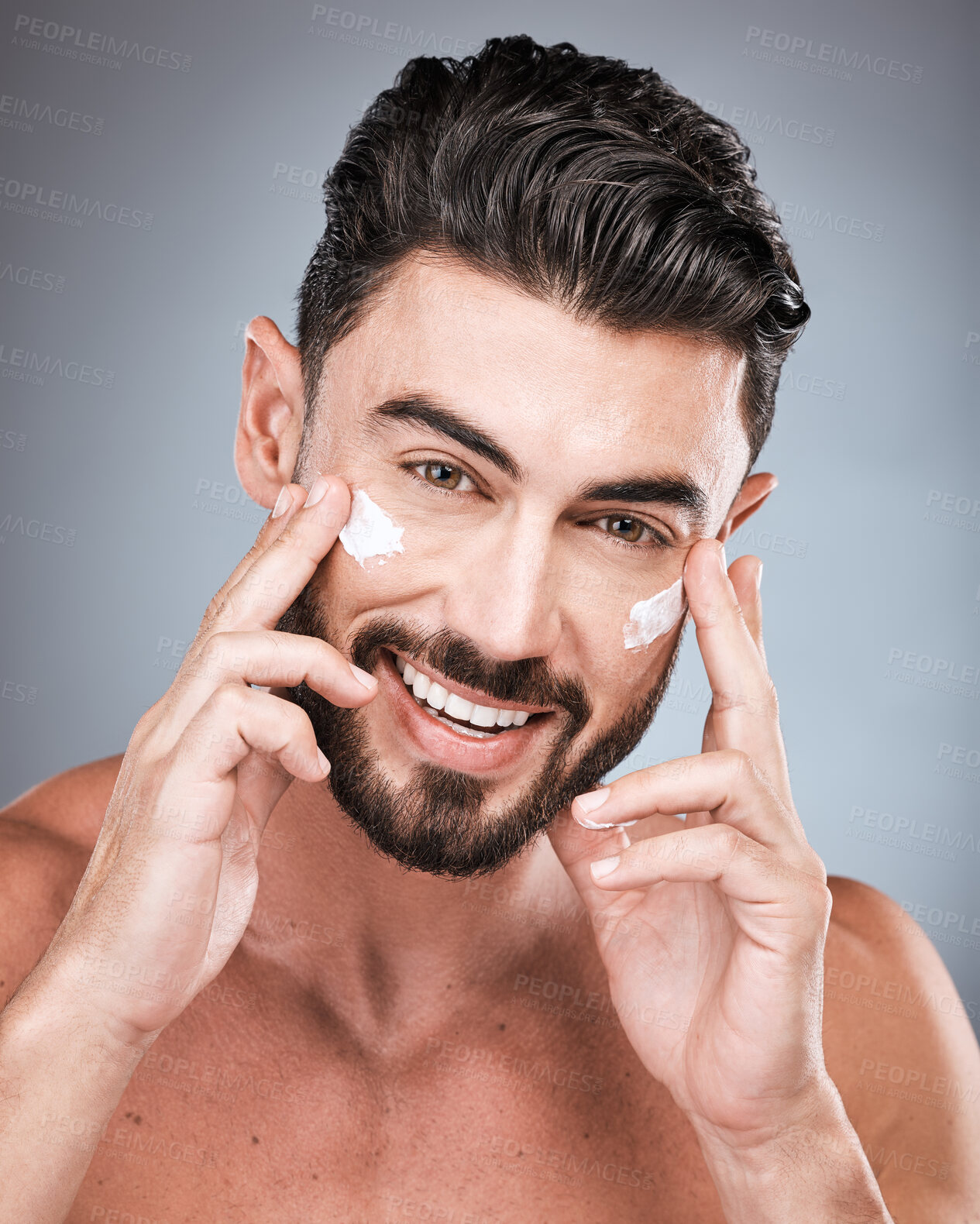 Buy stock photo Skincare, happy and portrait of a man with face cream isolated on a grey studio background. Beauty, grooming and model with facial sunscreen for body dermatology, hygiene and protection on a backdrop