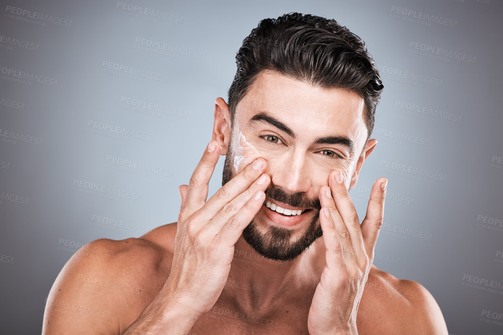 Buy stock photo Face portrait, skincare and man with cream in studio isolated on a gray background for facial wellness. Cosmetics, dermatology or happy male model with lotion, creme or moisturizer product for health