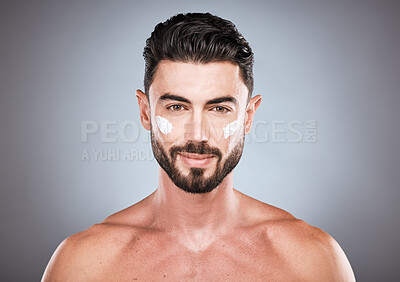 Buy stock photo Face portrait, skincare cream and man in studio isolated on a gray background for wellness. Cosmetics, dermatology and young male model with lotion, creme or moisturizer product for facial health.