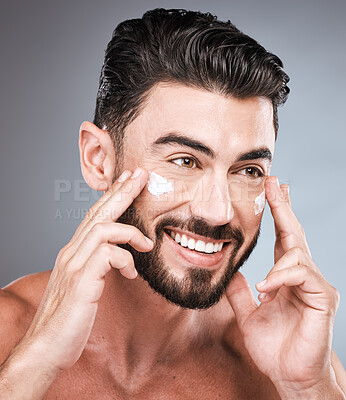 Buy stock photo Skincare, cream and face of man in studio isolated on a gray background for wellness. Thinking, dermatology and happy male model apply lotion cosmetics, creme or moisturizer product for facial health