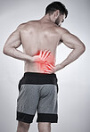 Fitness, hands or sports man with back pain after exercise, body training injury or gym workout with muscle pain. Red glow, spine or injured bodybuilder suffering alone isolated on studio background