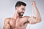 Fitness, body and strong man with tape measure for biceps for exercise goals on studio background. Happy bodybuilder measuring arm for training, workout or muscle growth progress, results or target