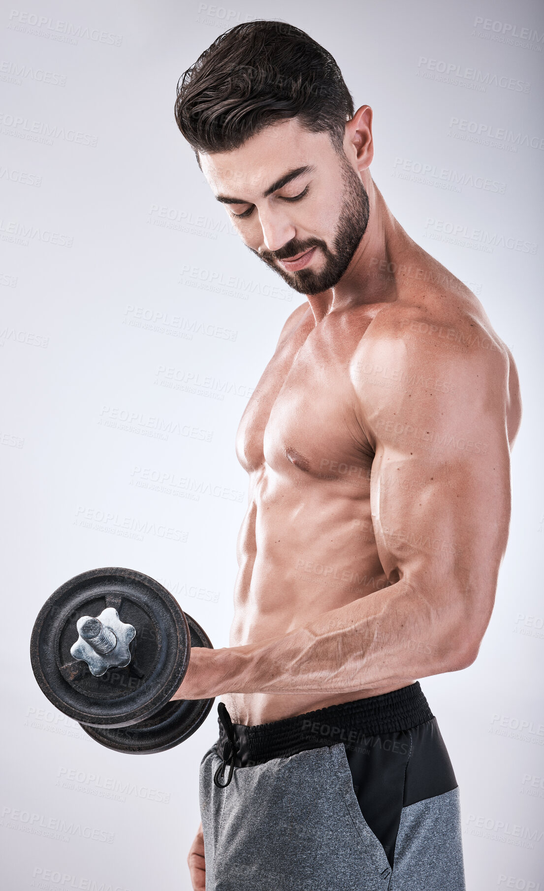 Buy stock photo Fitness, power or strong man with a dumbbell in training, exercise or gym workout for body goals. Sports motivation, focus or healthy bodybuilder weightlifting for biceps growth isolated in studio