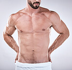 Fitness, abs or body of a man cleaning for wellness, luxury skincare or self love on studio background. Spa, sexy chest or topless male model with a towel after washing for health and natural hygiene