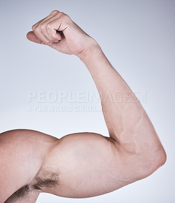 Buy stock photo Arm muscle, man and fist with body, health and fitness with strong person isolated on studio background. Skin, bodybuilder and flex biceps, wellness and weightlifting, exercise growth and muscular