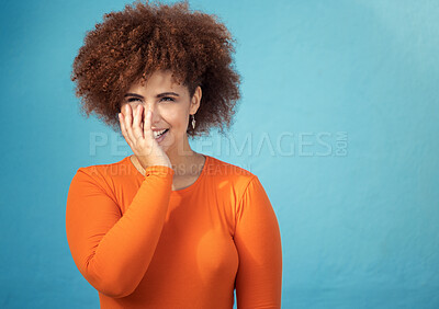 Buy stock photo Happy, shy and young woman in studio with a positive, optimistic and innocent mindset. Happiness, giggle and excited female model from Mexico with smile posing while isolated by turquoise background.