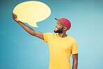 Speech bubble, advertising and black man on blue background for announcement, news and information. Marketing, opinion mockup and male smile with copy space on poster, billboard and sign for voice