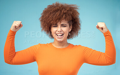 Buy stock photo Portrait, strong and bicep with a black woman in studio on a blue background flexing her muscle for empowerment. Face, equality and power with an attractive young female posing to promote health