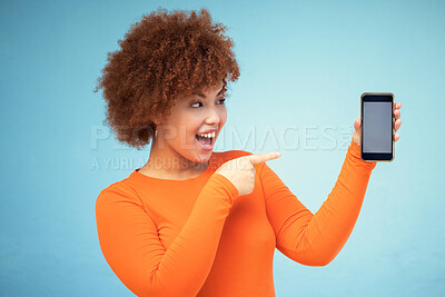 Buy stock photo Woman, excited and phone mockup screen advertising sale, promotion or brand on website or internet. Person pointing hand at smartphone on blue background studio for about us or online winning deal