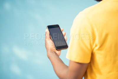 Buy stock photo Hand, phone and mockup screen with man reading sale, promotion or email for brand on website. Person with smartphone on blue background in studio for about us, online contact or network connection