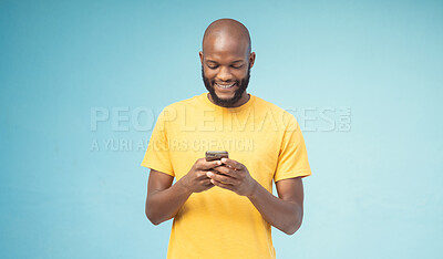 Buy stock photo Black man, phone or typing on blue background, isolated mockup or wall mock up on social media, internet app or blogging. Smile, happy person or fashion clothes on mobile technology for trendy ideas