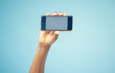 Buy stock photo Phone, mockup screen and man hand advertising sale, promotion or brand on website or internet. Person with smartphone in hand on blue background studio for contact us, online contact or connection